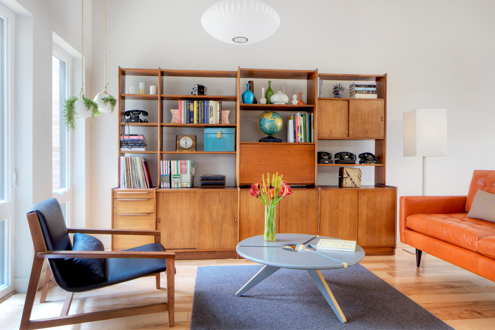 Danish light wood floor living room photo in Chicago with white walls