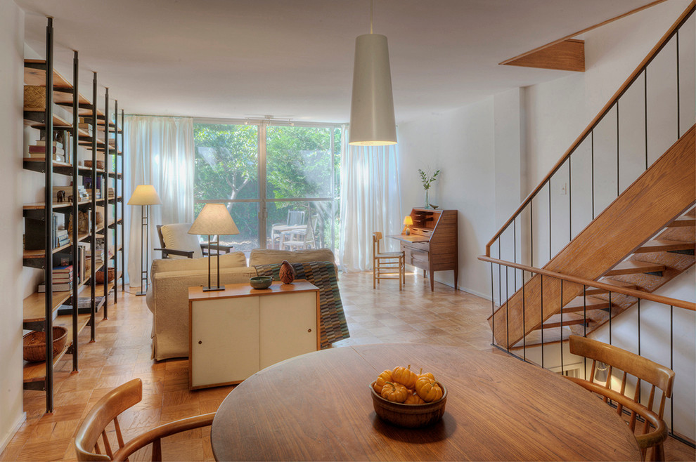 Inspiration for a modern medium tone wood floor living room remodel in DC Metro with white walls