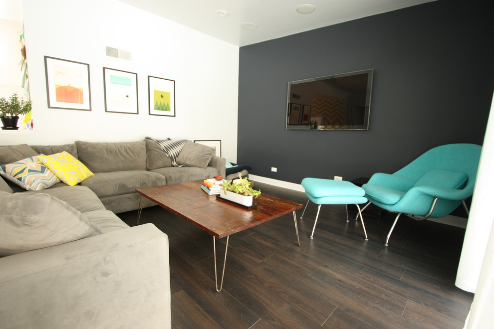Photo of a medium sized modern enclosed living room in Chicago with white walls, dark hardwood flooring and no fireplace.
