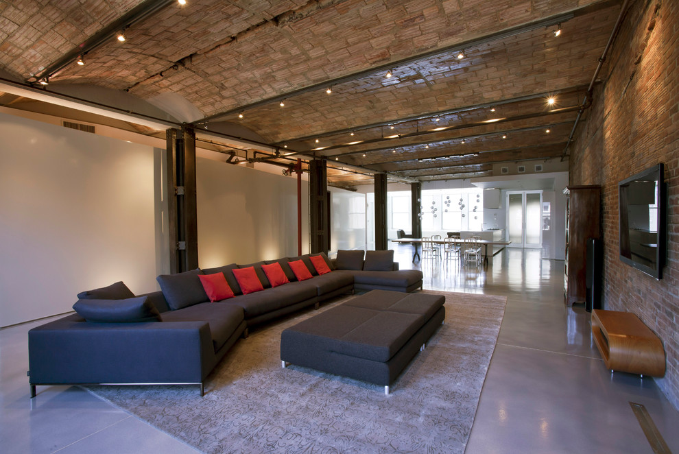 Immagine di un soggiorno industriale con pavimento in cemento