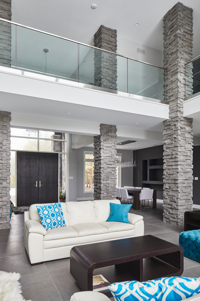 Inspiration for an expansive modern formal mezzanine living room with grey walls, slate flooring, a ribbon fireplace, a stone fireplace surround, no tv and grey floors.