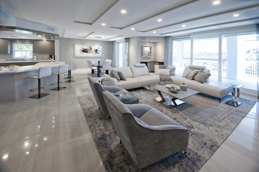This is an example of a large contemporary open plan living room in Miami with grey walls, porcelain flooring, a built-in media unit, grey floors, a drop ceiling and wallpapered walls.