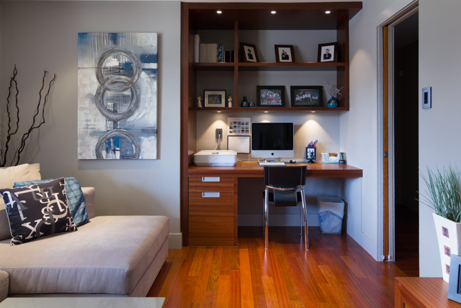 Small minimalist medium tone wood floor living room library photo in Ottawa with white walls