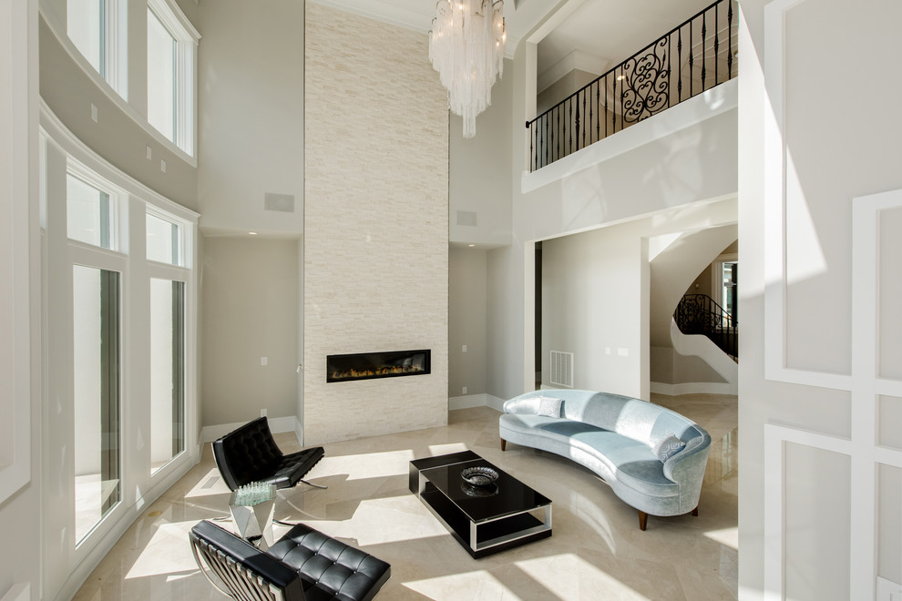 Стильный дизайн: большая парадная, открытая гостиная комната в стиле модернизм с серыми стенами, мраморным полом, подвесным камином, фасадом камина из камня и бежевым полом без телевизора - последний тренд