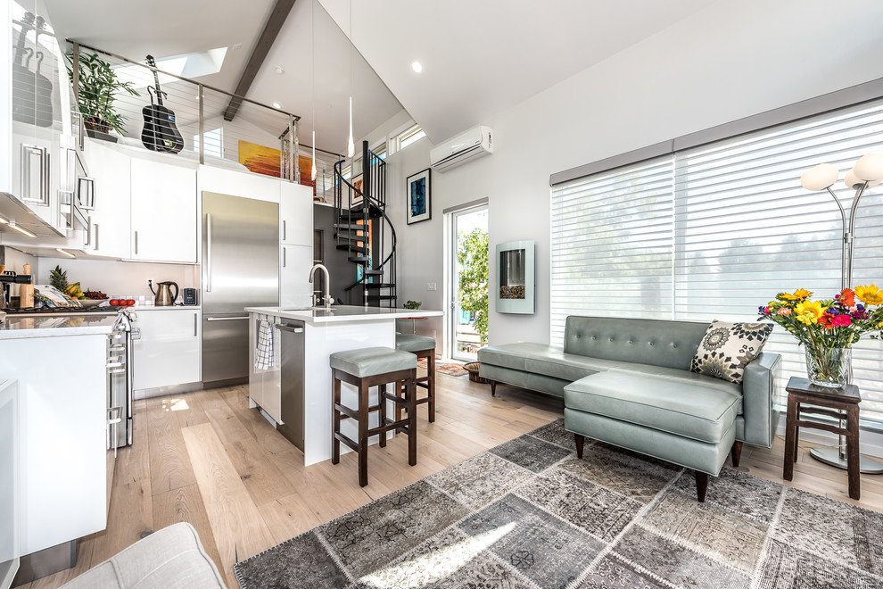 Inspiration for a small contemporary light wood floor living room remodel in Denver with white walls and no fireplace