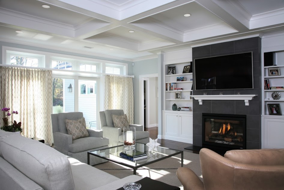 Photo of a large modern formal enclosed living room in Boston with grey walls, dark hardwood flooring, a standard fireplace, a tiled fireplace surround, a wall mounted tv and brown floors.