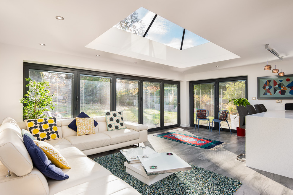 Mid-sized transitional open concept slate floor and gray floor living room photo in Hampshire with white walls