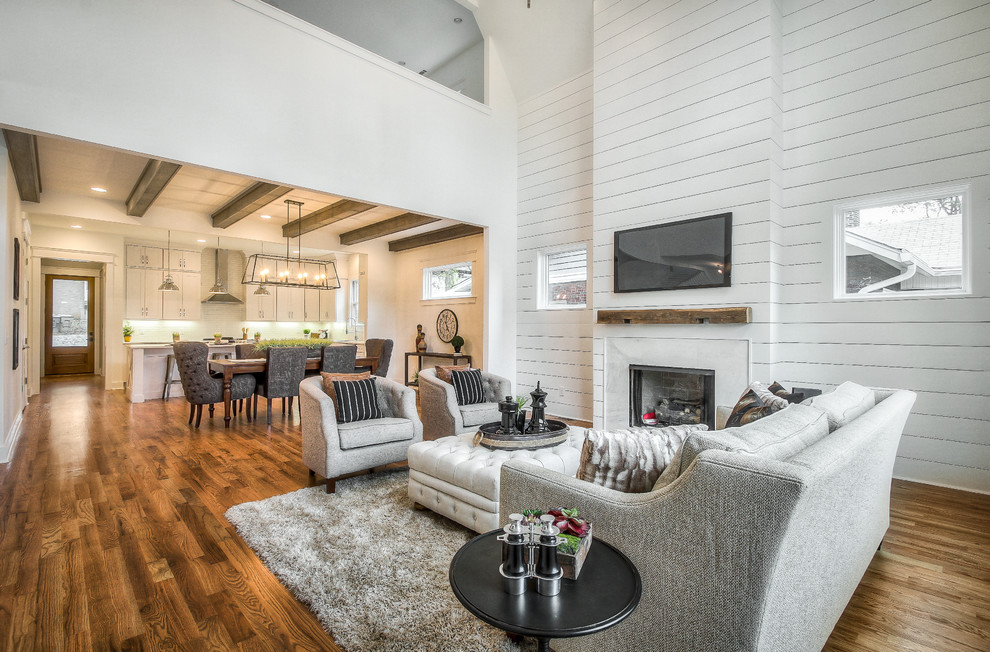 Large traditional open plan living room in Nashville with white walls, medium hardwood flooring, a standard fireplace, a stone fireplace surround and a wall mounted tv.