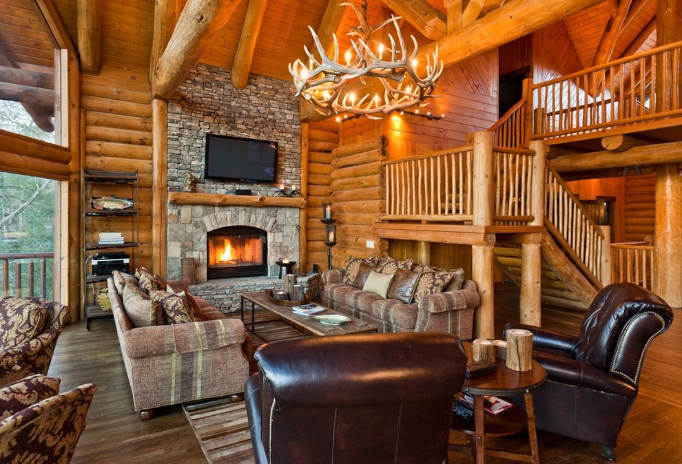 Example of a mountain style living room design in Dallas with a stone fireplace