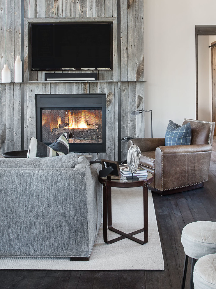 Inspiration for a rustic open concept dark wood floor living room remodel in Salt Lake City with beige walls, a standard fireplace and a wall-mounted tv
