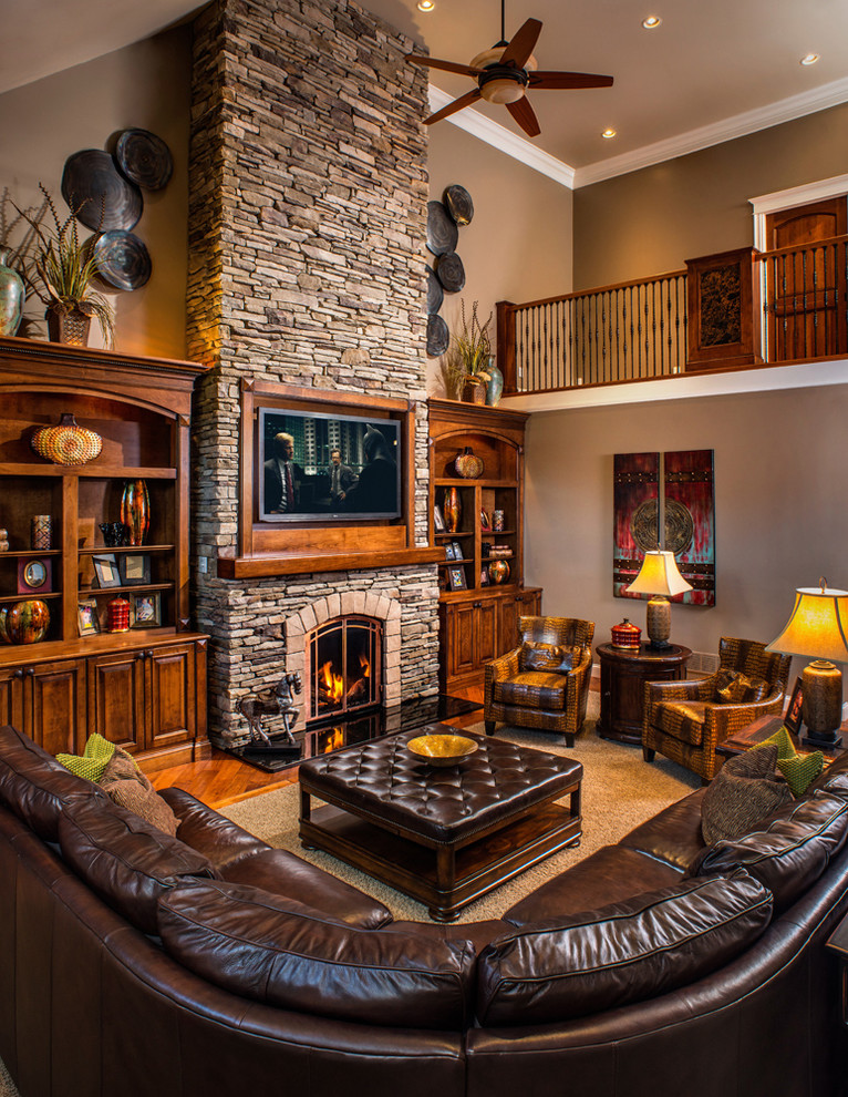 Rustic living room in Charleston with a stone fireplace surround and feature lighting.