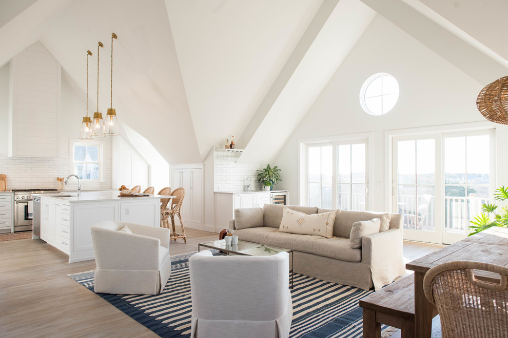 This is an example of a medium sized coastal formal open plan living room in Boston with white walls, light hardwood flooring, no fireplace, beige floors and a wall mounted tv.