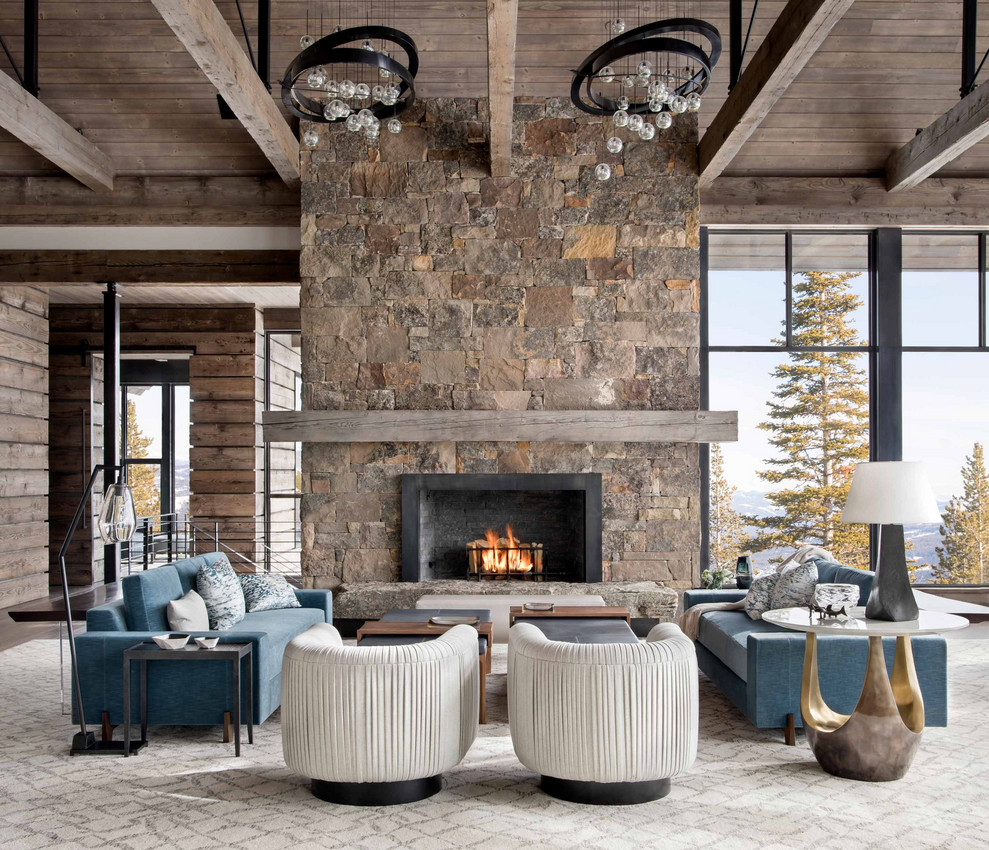 Photo of a rustic open plan living room in Other with medium hardwood flooring, a standard fireplace, a stone fireplace surround, no tv and a vaulted ceiling.