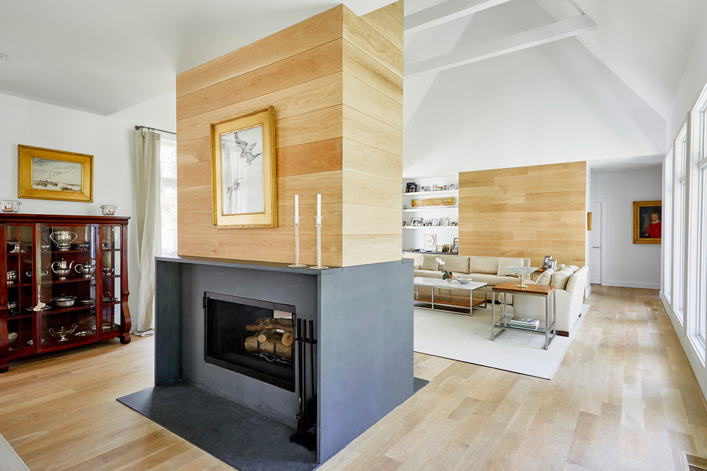 Example of a large trendy formal and open concept light wood floor and beige floor living room design in Richmond with white walls, a two-sided fireplace, a concrete fireplace and a wall-mounted tv