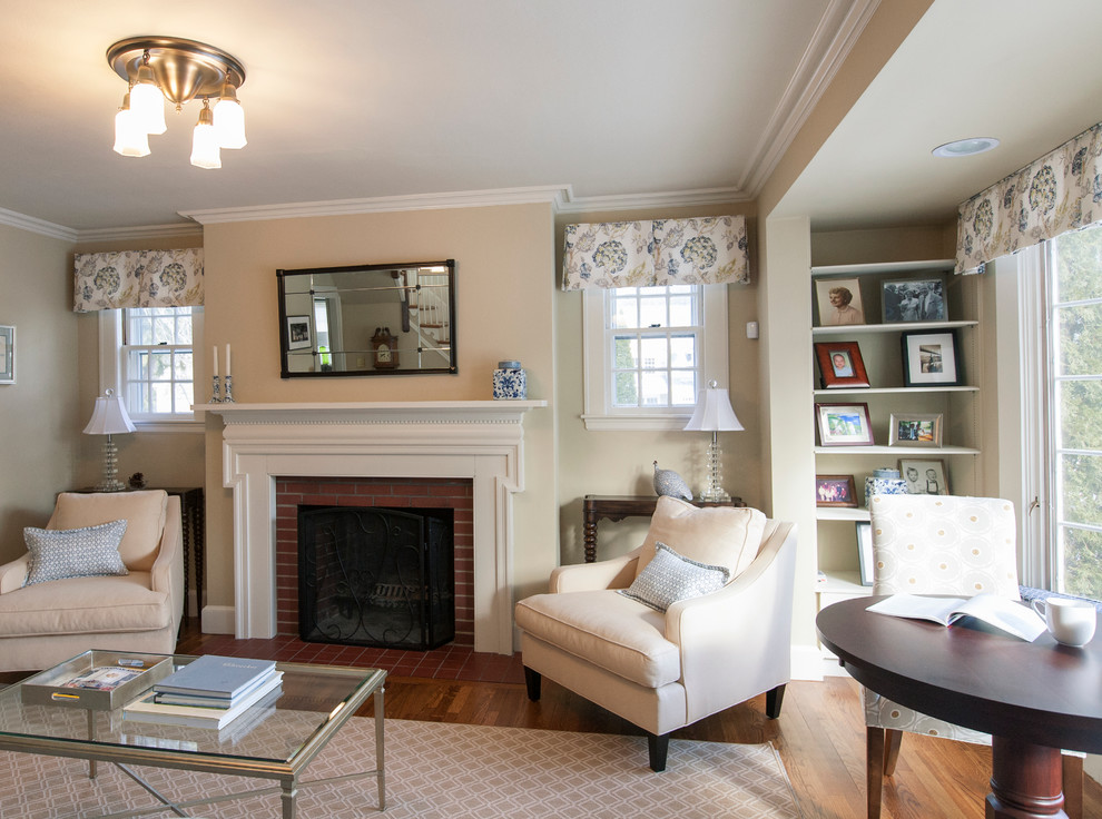 Example of a mid-sized classic formal and open concept medium tone wood floor living room design in Boston with beige walls, a standard fireplace, a brick fireplace and no tv