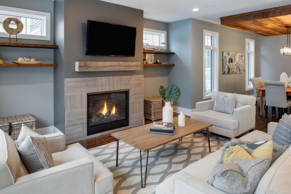 This is an example of a medium sized traditional formal open plan living room in Minneapolis with grey walls, medium hardwood flooring, a standard fireplace, a tiled fireplace surround and a wall mounted tv.