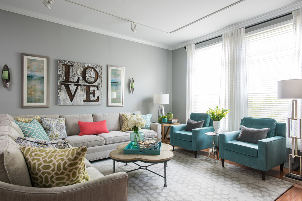 This is an example of a medium sized modern grey and teal open plan living room in Dallas with grey walls, light hardwood flooring, no fireplace and feature lighting.