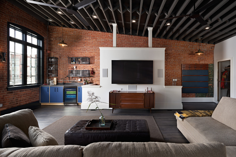 Inspiration for a large industrial open concept vinyl floor, gray floor, exposed beam and brick wall living room remodel in Other with a bar, no fireplace and a wall-mounted tv