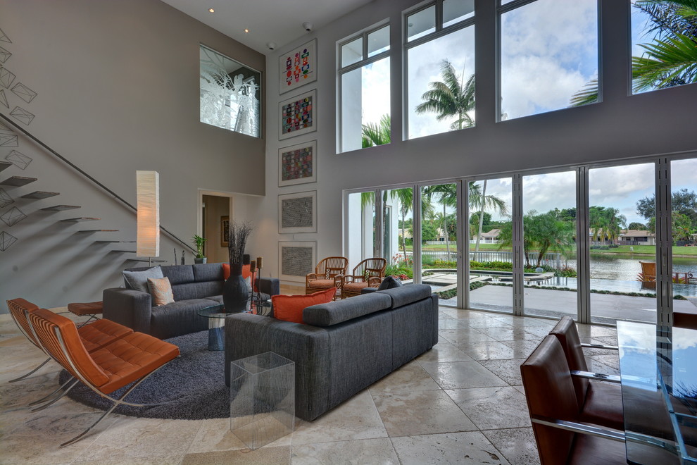 This is an example of a large contemporary formal open plan living room in Miami with grey walls, ceramic flooring, no fireplace and no tv.