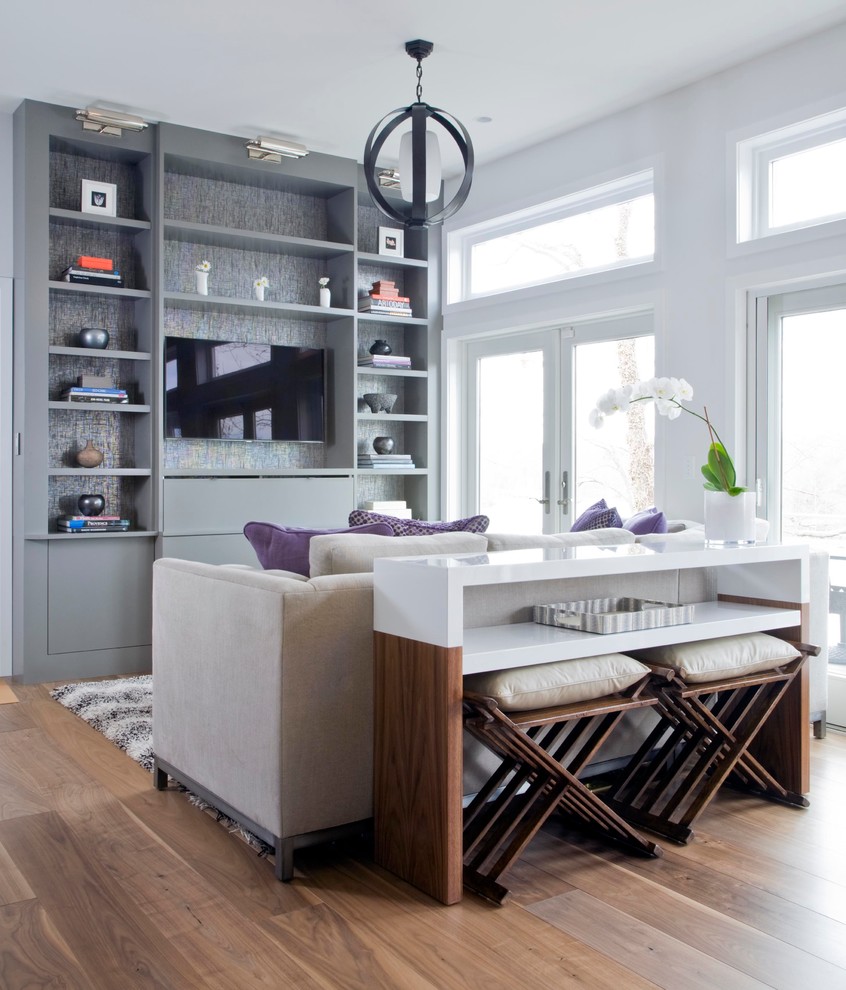 Living room - contemporary open concept medium tone wood floor living room idea in Miami with white walls and a wall-mounted tv