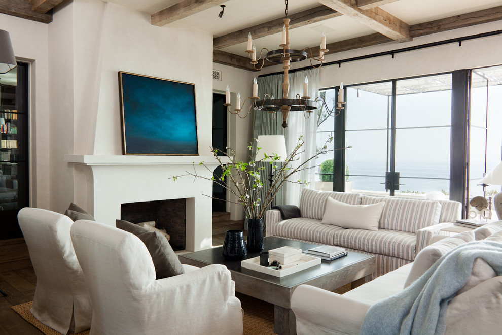 This is an example of a mediterranean enclosed living room in Orange County with a standard fireplace.