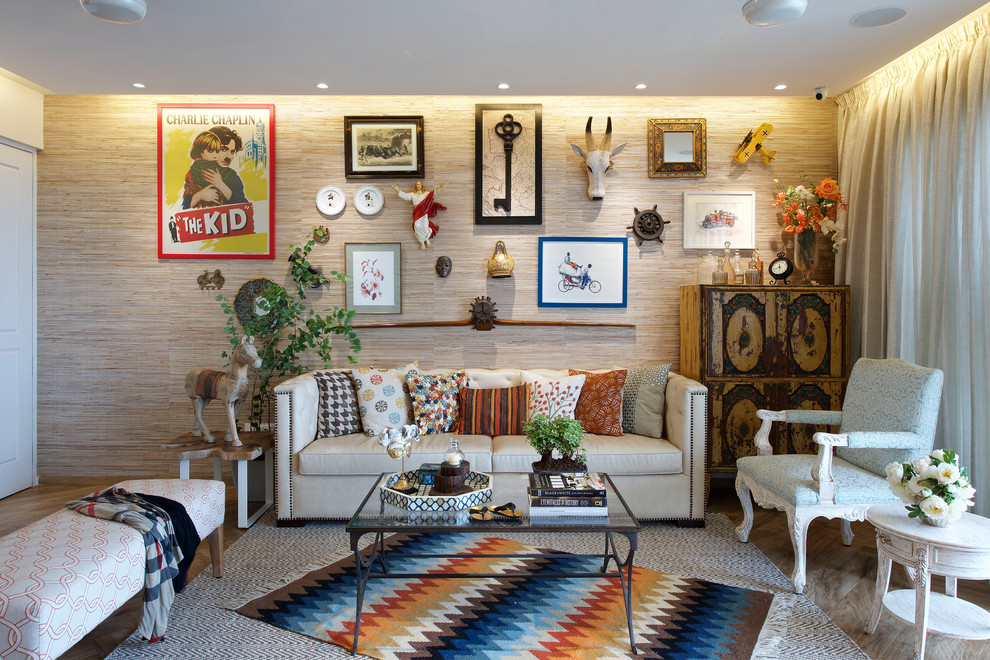 Inspiration for a bohemian living room in Mumbai with beige walls, medium hardwood flooring and no tv.