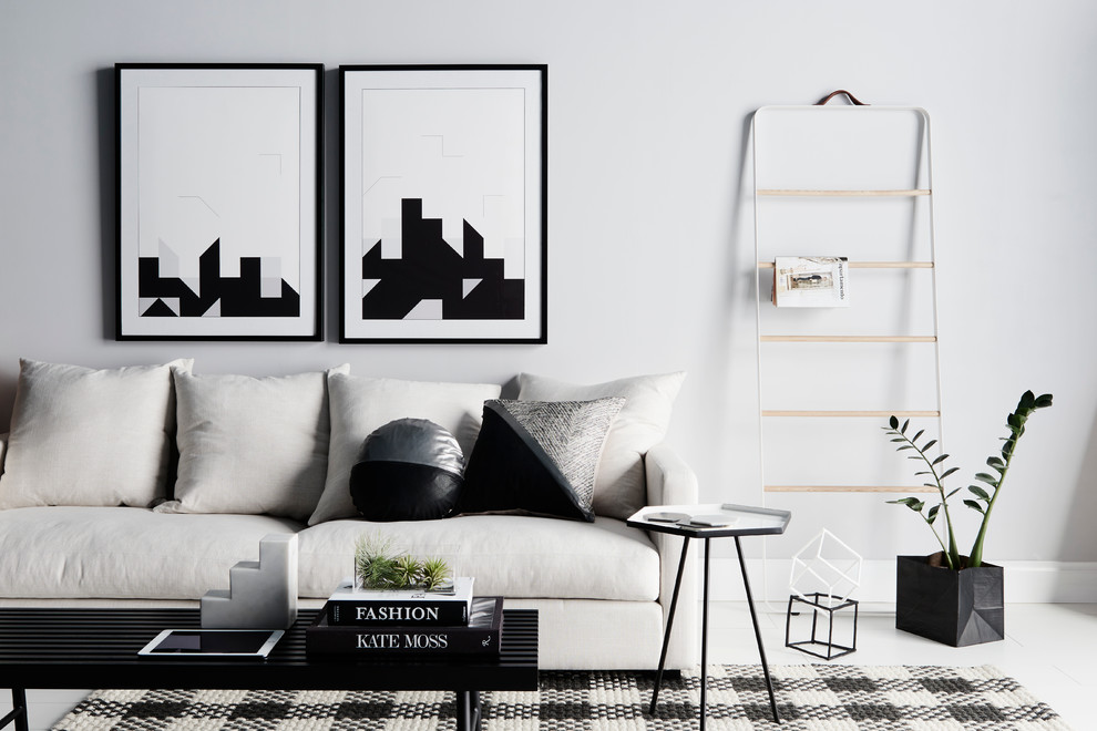 Inspiration pour un salon minimaliste avec un mur blanc.