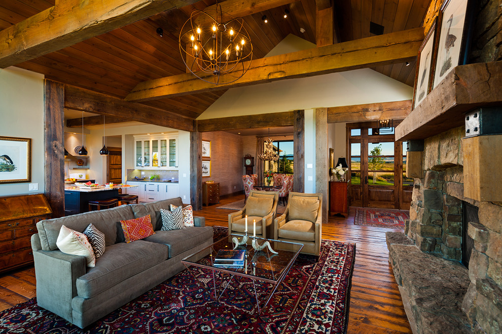 Eclectic living room in Other with dark hardwood flooring and a stone fireplace surround.