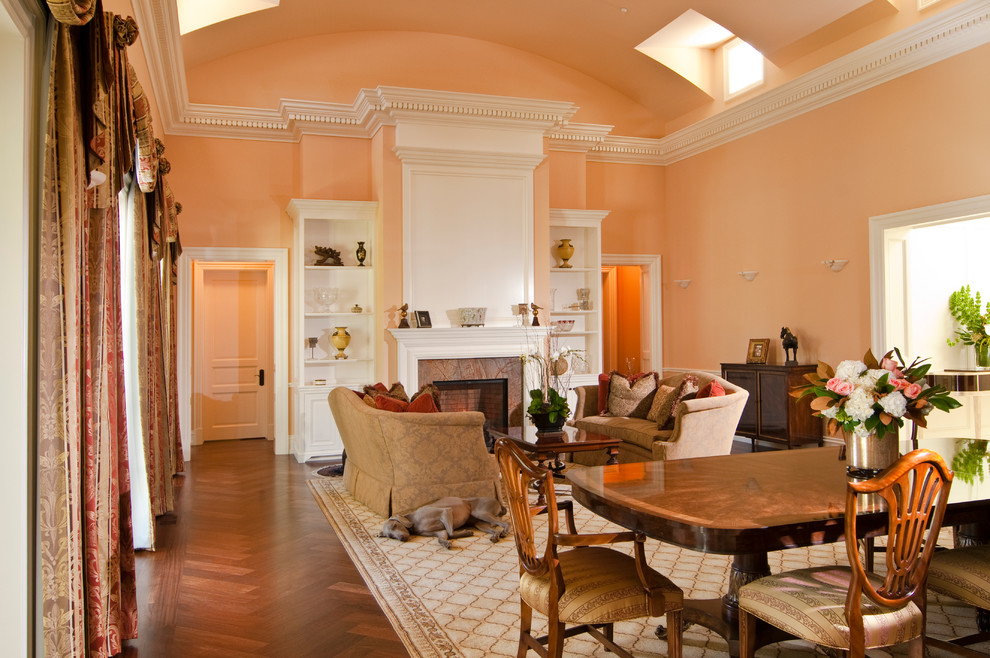 Inspiration for a timeless formal and open concept medium tone wood floor living room remodel in San Francisco with pink walls, a standard fireplace and no tv