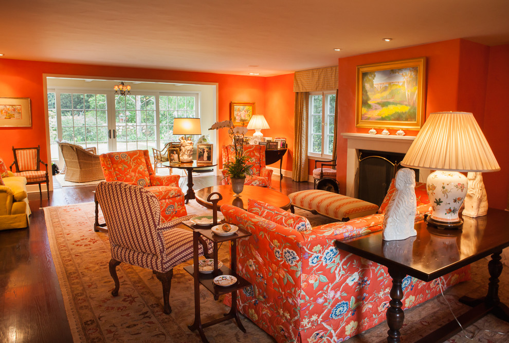 На фото: парадная, изолированная гостиная комната среднего размера в классическом стиле с оранжевыми стенами, темным паркетным полом, стандартным камином, фасадом камина из плитки и коричневым полом без телевизора с