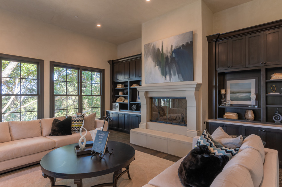 Expansive formal open plan living room in Other with beige walls, dark hardwood flooring, a standard fireplace, a stone fireplace surround, no tv and brown floors.
