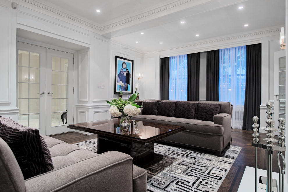 Immagine di un soggiorno design con pareti bianche e parquet scuro