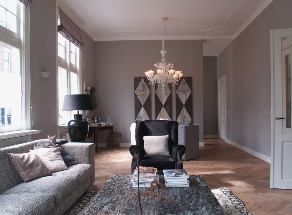 Example of a trendy living room design in Amsterdam with gray walls