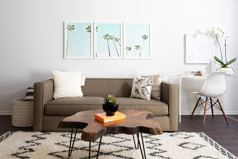 Midcentury living room in Los Angeles with white walls, dark hardwood flooring and brown floors.