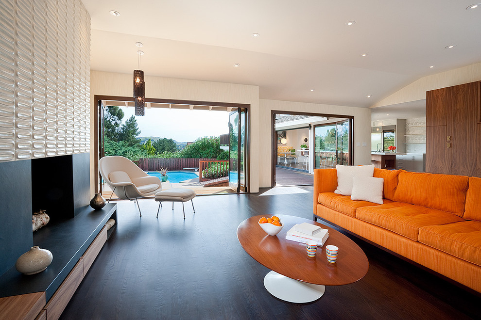 Esempio di un soggiorno moderno aperto con pareti beige, parquet scuro, camino classico e pavimento marrone
