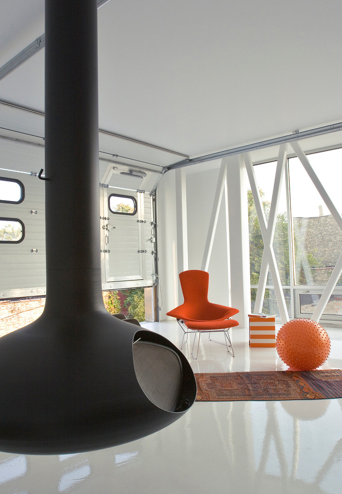 Idee per un soggiorno minimalista di medie dimensioni e aperto con sala formale, pareti bianche, pavimento in cemento e camino sospeso