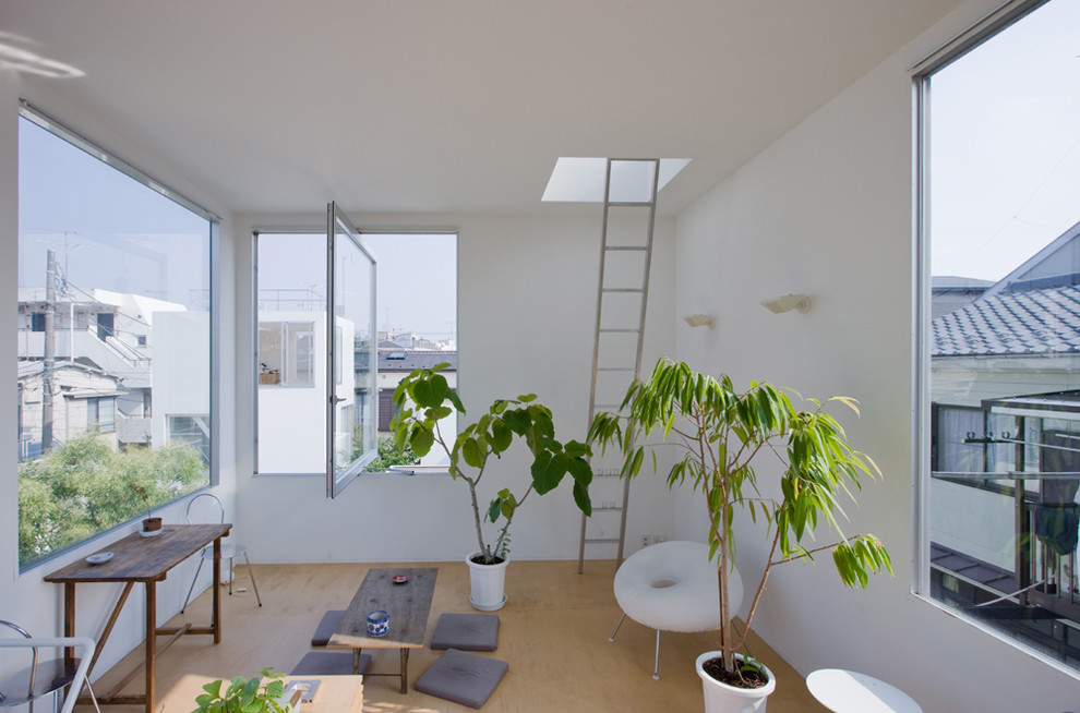 Living room - small contemporary living room idea in Other with white walls