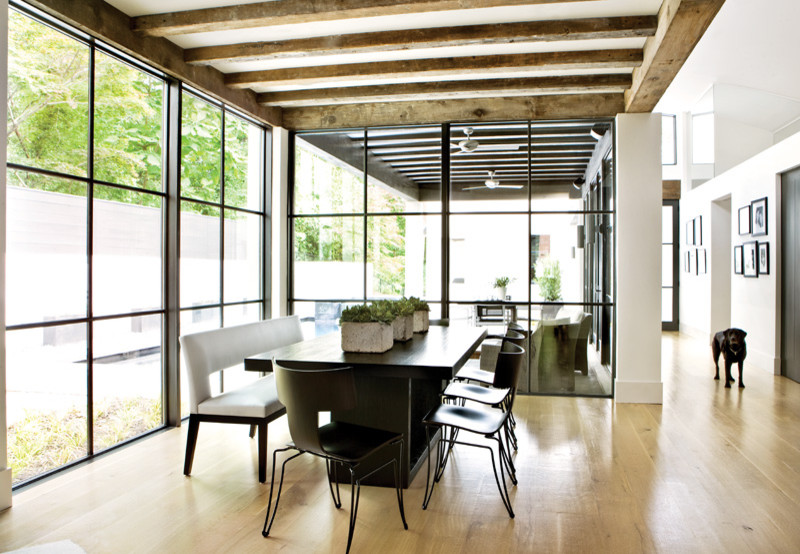 Dining room - modern light wood floor dining room idea in Atlanta with white walls