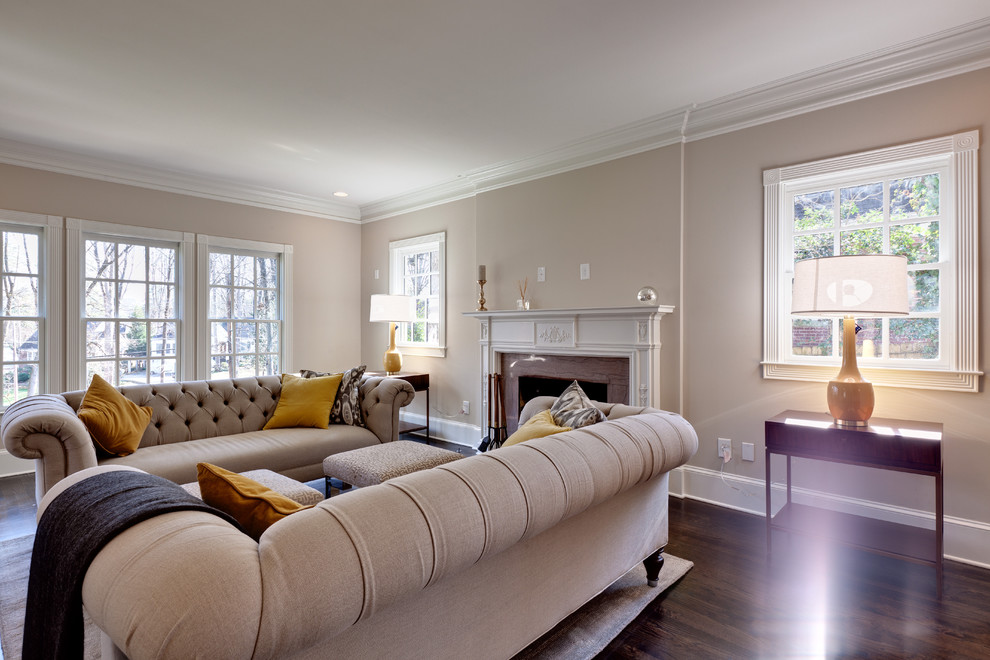 Inspiration pour un salon traditionnel de taille moyenne et ouvert avec un mur beige, une cheminée standard, une salle de réception, parquet foncé, un manteau de cheminée en pierre et aucun téléviseur.