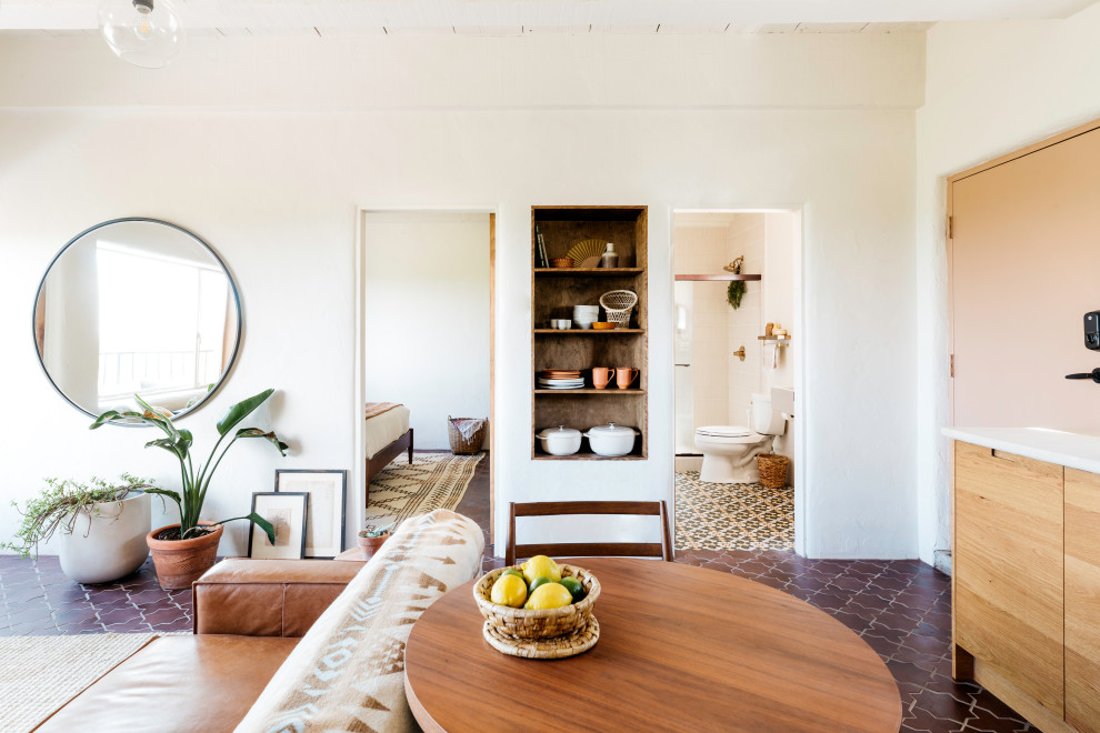 Großes, Repräsentatives, Fernseherloses, Offenes Mediterranes Wohnzimmer mit beiger Wandfarbe, Keramikboden, Eckkamin und braunem Boden in Phoenix