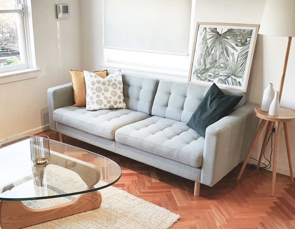 Inspiration for a medium sized scandi formal enclosed living room in Sydney with white walls, light hardwood flooring, no fireplace, a freestanding tv and brown floors.