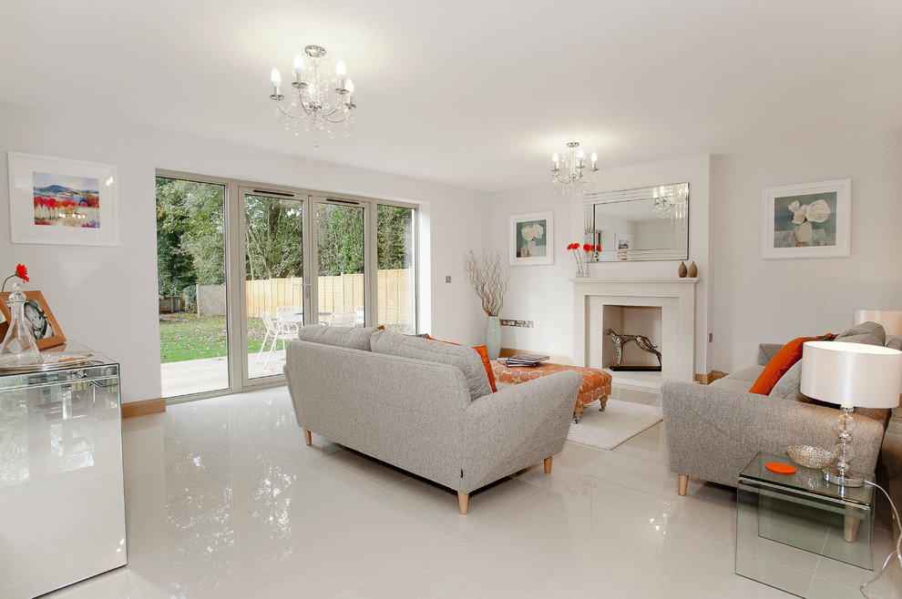 Minimalist white floor living room photo in Dorset with white walls and a standard fireplace