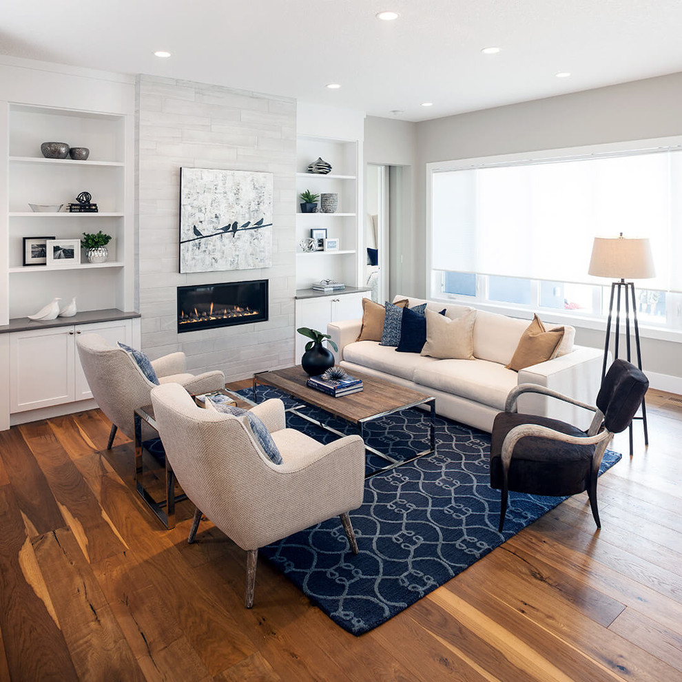 Photo of a medium sized traditional open plan living room in Calgary with white walls, light hardwood flooring, a ribbon fireplace and a metal fireplace surround.