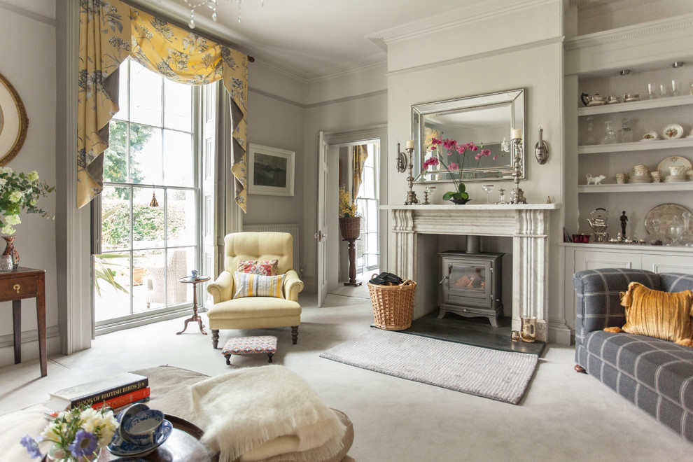 Photo of a classic formal enclosed living room in Other with grey walls, carpet, a wood burning stove and grey floors.