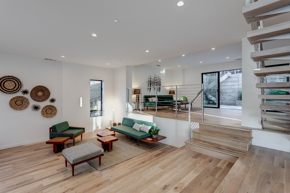 Inspiration for a large contemporary formal and open concept light wood floor living room remodel in Los Angeles with white walls, no fireplace and no tv