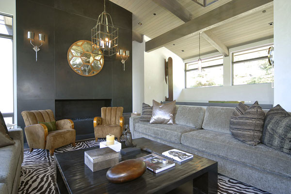 This is an example of a large contemporary open plan living room in Denver with beige walls, a standard fireplace and a concrete fireplace surround.