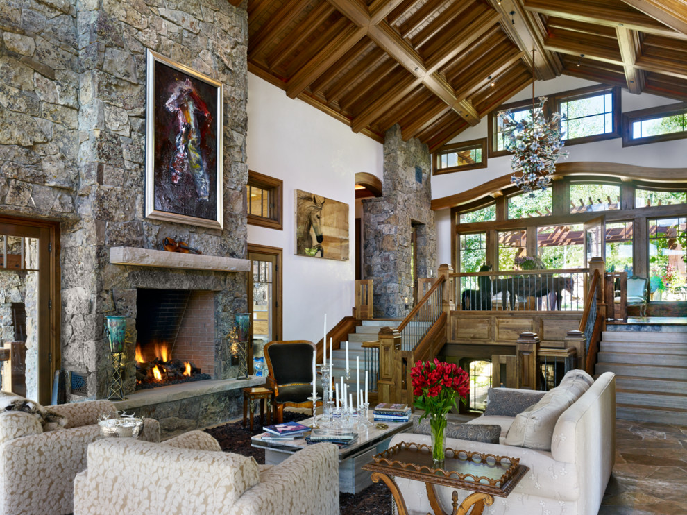 Inspiration for a large rustic formal open plan living room in Denver with white walls, a standard fireplace, a stone fireplace surround and no tv.
