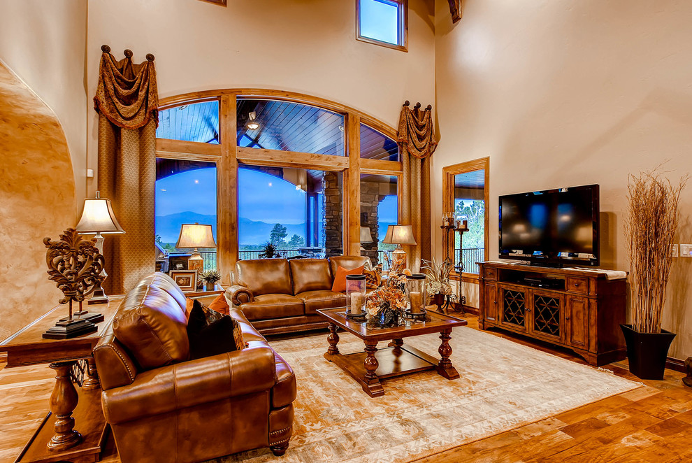 Example of a large arts and crafts formal and open concept medium tone wood floor living room design in Denver with a standard fireplace, a stone fireplace and a tv stand