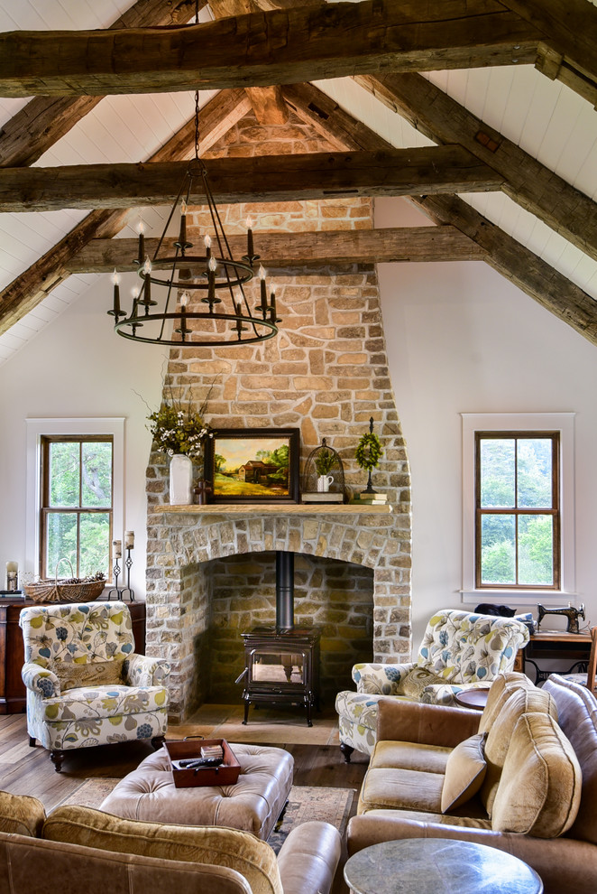 Inspiration for a country open concept and formal dark wood floor and brown floor living room remodel in Other with white walls, a wood stove and a stone fireplace