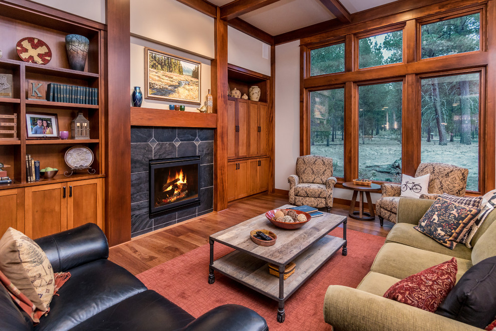 Exemple d'un salon montagne avec une salle de réception, un mur beige, une cheminée standard, un manteau de cheminée en carrelage, aucun téléviseur et un sol en bois brun.